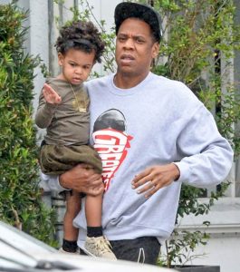 Dad Jay-Z holds Blue Ivy as the heads towards car